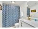 Bright bathroom featuring modern fixtures, blue shower curtain, and a large mirror at 1723 Live Oak Park, Seabrook Island, SC 29455