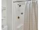 Clean shower stall with a bronze shower head, soap storage, and a decorative shower curtain at 1723 Live Oak Park, Seabrook Island, SC 29455