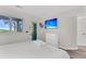 Calm bedroom with a plush white bed, a wall-mounted TV, and a door to a private outdoor space at 1723 Live Oak Park, Seabrook Island, SC 29455