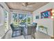 Charming sunroom dining area with wicker chairs and views of the marsh at 1723 Live Oak Park, Seabrook Island, SC 29455