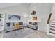 Inviting living room features bright wall art, two sofas, and a nearby staircase at 1723 Live Oak Park, Seabrook Island, SC 29455