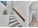 Bright stairway with a hardwood banister, leading to an arched doorway and bathroom at 1723 Live Oak Park, Seabrook Island, SC 29455