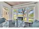 Bright sunroom featuring large windows with scenic marsh views and comfortable wicker seating at 1723 Live Oak Park, Seabrook Island, SC 29455