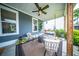 Charming covered back porch with swing, comfortable seating, and a relaxing atmosphere to unwind and enjoy outdoors at 1726 Winfield Way, Charleston, SC 29414