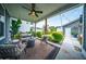 Relaxing covered back porch with comfortable seating, ceiling fan, and serene views of the backyard at 1726 Winfield Way, Charleston, SC 29414