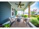 Inviting covered back porch with cozy seating, perfect for relaxing and enjoying the view of the backyard at 1726 Winfield Way, Charleston, SC 29414