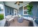 Stylish covered back porch featuring comfortable seating, neutral tones and a peaceful outdoor ambiance at 1726 Winfield Way, Charleston, SC 29414