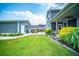 Spacious backyard with lush green lawn, stone patio, covered porch and pergola, perfect for outdoor activities at 1726 Winfield Way, Charleston, SC 29414