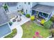 Aerial shot of a backyard featuring a patio area with a pergola, string lights and a manicured lawn at 1726 Winfield Way, Charleston, SC 29414