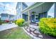 Expansive backyard featuring a covered porch, manicured landscaping, and stone walkway leading to the patio at 1726 Winfield Way, Charleston, SC 29414