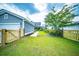 Spacious backyard with lush green grass, wood fence, and manicured landscaping at 1726 Winfield Way, Charleston, SC 29414