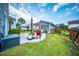 Lush backyard with well-maintained lawn, patio, and grilling area, all enclosed by a secure fence for privacy at 1726 Winfield Way, Charleston, SC 29414