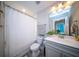 Bright bathroom featuring a shower with curtain, toilet, sink, and decorative mirror at 1726 Winfield Way, Charleston, SC 29414