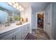 Updated bathroom featuring dual sinks, framed mirrors, and an open doorway to a walk-in closet at 1726 Winfield Way, Charleston, SC 29414