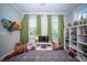 Bright and airy bedroom featuring a large rug, ceiling fan, and open storage shelves at 1726 Winfield Way, Charleston, SC 29414