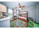 Cozy bedroom featuring a ceiling fan, bunk beds, and a playful city-themed rug on hardwood floors at 1726 Winfield Way, Charleston, SC 29414