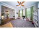 Bright and airy playroom featuring a large rug, ceiling fan, and open doorway at 1726 Winfield Way, Charleston, SC 29414