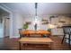 Dining area with a rustic wooden table set, bench seating, and elegant lighting for a cozy atmosphere at 1726 Winfield Way, Charleston, SC 29414