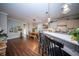 Bright and airy dining area featuring a modern light fixture, adjacent to the kitchen, and hardwood floors at 1726 Winfield Way, Charleston, SC 29414