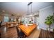 Bright dining area features a wooden table, bench seating, modern light fixture, and seamless flow to the living spaces at 1726 Winfield Way, Charleston, SC 29414