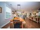 Open dining area with a rustic table, stylish decor, and views into the adjoining kitchen and living spaces at 1726 Winfield Way, Charleston, SC 29414