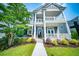 Charming two-story home with a welcoming front porch, lush landscaping, and a well-maintained lawn at 1726 Winfield Way, Charleston, SC 29414
