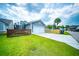 Home exterior with a well-maintained lawn, wood fence, and beautiful blue siding at 1726 Winfield Way, Charleston, SC 29414