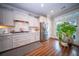 Charming kitchen with white cabinets, stainless steel fridge, hardwood floors, and bright natural light at 1726 Winfield Way, Charleston, SC 29414