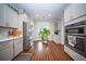 Open kitchen layout with stainless steel appliances, white cabinetry, and hardwood floors for a sleek and modern design at 1726 Winfield Way, Charleston, SC 29414
