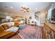 Beautiful living room features ceiling fan, leather couches, chairs, and seamless flow to dining and kitchen areas at 1726 Winfield Way, Charleston, SC 29414