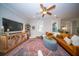 Bright living room with a ceiling fan, console table, leather sofa, and large rug creates a warm and inviting atmosphere at 1726 Winfield Way, Charleston, SC 29414