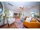 Cozy living room featuring ceiling fan, leather couches, chairs, and a patterned rug creates a warm, inviting atmosphere at 1726 Winfield Way, Charleston, SC 29414