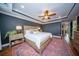Comfortable primary bedroom with a ceiling fan, tray ceilings, and a view of the en suite bathroom at 1726 Winfield Way, Charleston, SC 29414
