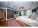 Spacious primary bedroom with an accent wall, wood floors, and ample natural light from the large windows at 1726 Winfield Way, Charleston, SC 29414