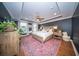 Well-lit primary bedroom with a tray ceiling, wood floors, and a ceiling fan adding a touch of elegance and comfort at 1726 Winfield Way, Charleston, SC 29414