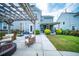 Stylish outdoor patio with pergola, fire pit, and comfortable seating, ideal for entertaining guests or relaxing at 1726 Winfield Way, Charleston, SC 29414