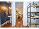 Elegant powder room showcases a pedestal sink, gold mirror, stylish lighting, and view into the dining area at 1726 Winfield Way, Charleston, SC 29414