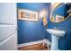 Cozy powder room features a pedestal sink, gold mirror, accent lighting, and stylish decor at 1726 Winfield Way, Charleston, SC 29414