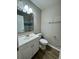 A bright bathroom featuring vanity with a sink, mirror, toilet, and laminate flooring at 1820 Mepkin Rd # 1019, Charleston, SC 29407