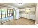 Kitchen with white appliances, cabinets, countertop, and sliding door to outdoor patio at 1820 Mepkin Rd # 1019, Charleston, SC 29407