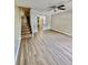 An open living room features laminate flooring, staircase, and ceiling fan at 1820 Mepkin Rd # 1019, Charleston, SC 29407