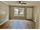 A well-lit living room with laminate flooring, a large window, and neutral paint at 1820 Mepkin Rd # 1019, Charleston, SC 29407