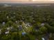 Expansive aerial view of a residential area, featuring tree-lined streets and various houses within the community at 1989 Nitsa St, Johns Island, SC 29455