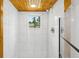 Shower featuring white tile, chrome fixtures, glass door and awning style window letting in lots of natural light at 1989 Nitsa St, Johns Island, SC 29455