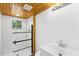 Modern bathroom boasts white tiled walls, a glass enclosed shower, and a vanity with chrome fixtures at 1989 Nitsa St, Johns Island, SC 29455