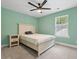 Cozy light green bedroom with a bed, bedside table, and a window letting in natural light at 1989 Nitsa St, Johns Island, SC 29455