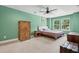 Bedroom with light green walls, a decorative wood cabinet and wardrobe, and two windows at 1989 Nitsa St, Johns Island, SC 29455