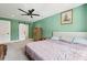 Bedroom with neutral carpet, queen bed, ceiling fan, barn door closet, and wooden wardrobe at 1989 Nitsa St, Johns Island, SC 29455
