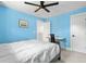 Bright blue bedroom featuring neutral colored accents and a work space with great lighting at 1989 Nitsa St, Johns Island, SC 29455