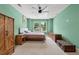 Bright bedroom features neutral carpet, wooden furniture, ceiling fan, and a double window with neighborhood views at 1989 Nitsa St, Johns Island, SC 29455